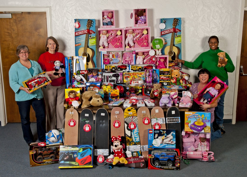 The faculty and staff at the Loma Linda School of Allied Health Professions were happy to be able to help with the Giving Tree program.  Together they donated more than 100 toys filling the wishes of children in Rialto, Highland, Grand Terrace, Colton, and San Bernardino.  To the left of the presents is Debbie Becker and me Kathy Poss.  To the right is Shirley Sing (kneeling) and Dana McCree.  (photo by Loma Linda School of Allied Health) 