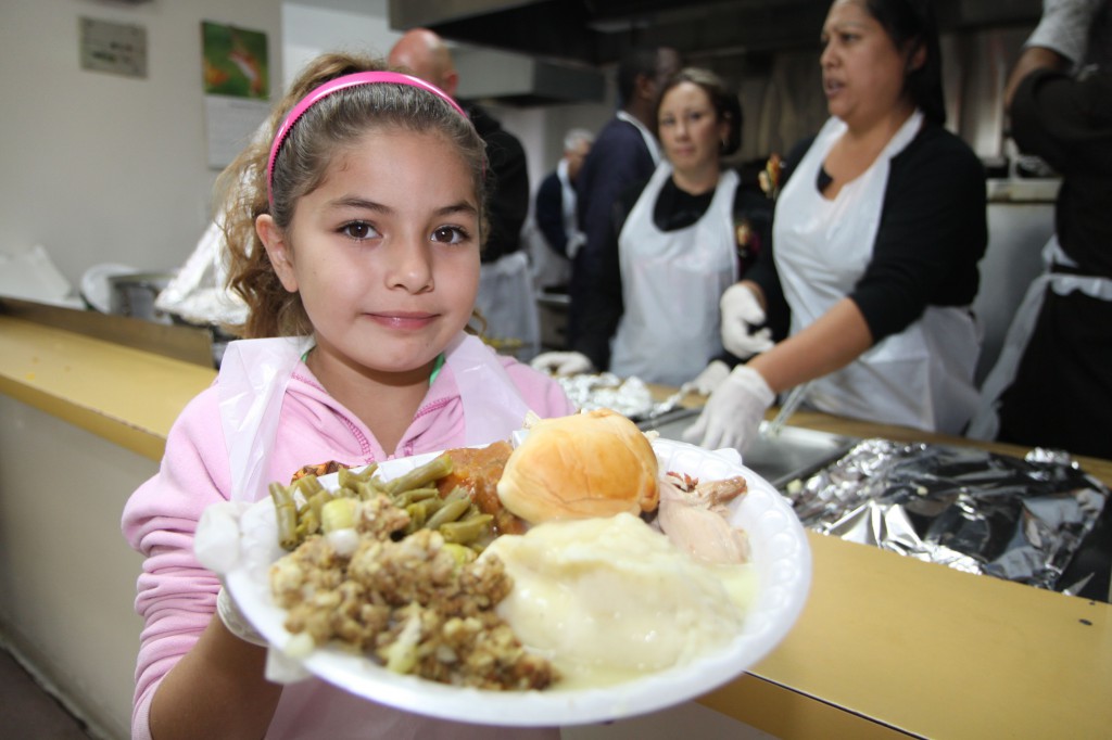 Proving that you are not too young to make a difference, Rae Ann Ortiz volunteers to serve holiday meals at the Salvation Army San Bernardino Corp. Photo by Ricardo Tomboc