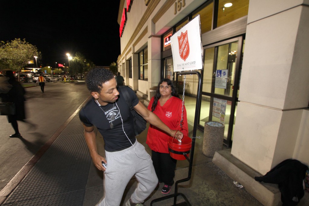 At the 40th Street Stater Bros. market, Joyce Fierri another Salvation Army bell ringer stands by her kettle. Joyce attends the Salvation Army Corps church and is a supporter of the organization. While taking Joyce's photograph, Mr. Andrew Williams steps up to the kettle to make his donation. Andrew is a long time supporter of the Salvation Army. Andrew is also an employee of Stater Bros. at a different store location. The next donation in Joyce's kettle came from a homeless man by the name of "Josh". As Josh walked up to kettle and dropped in a few coins, and apologizes to Joyce for his small contribution, and he wished it could be much more.